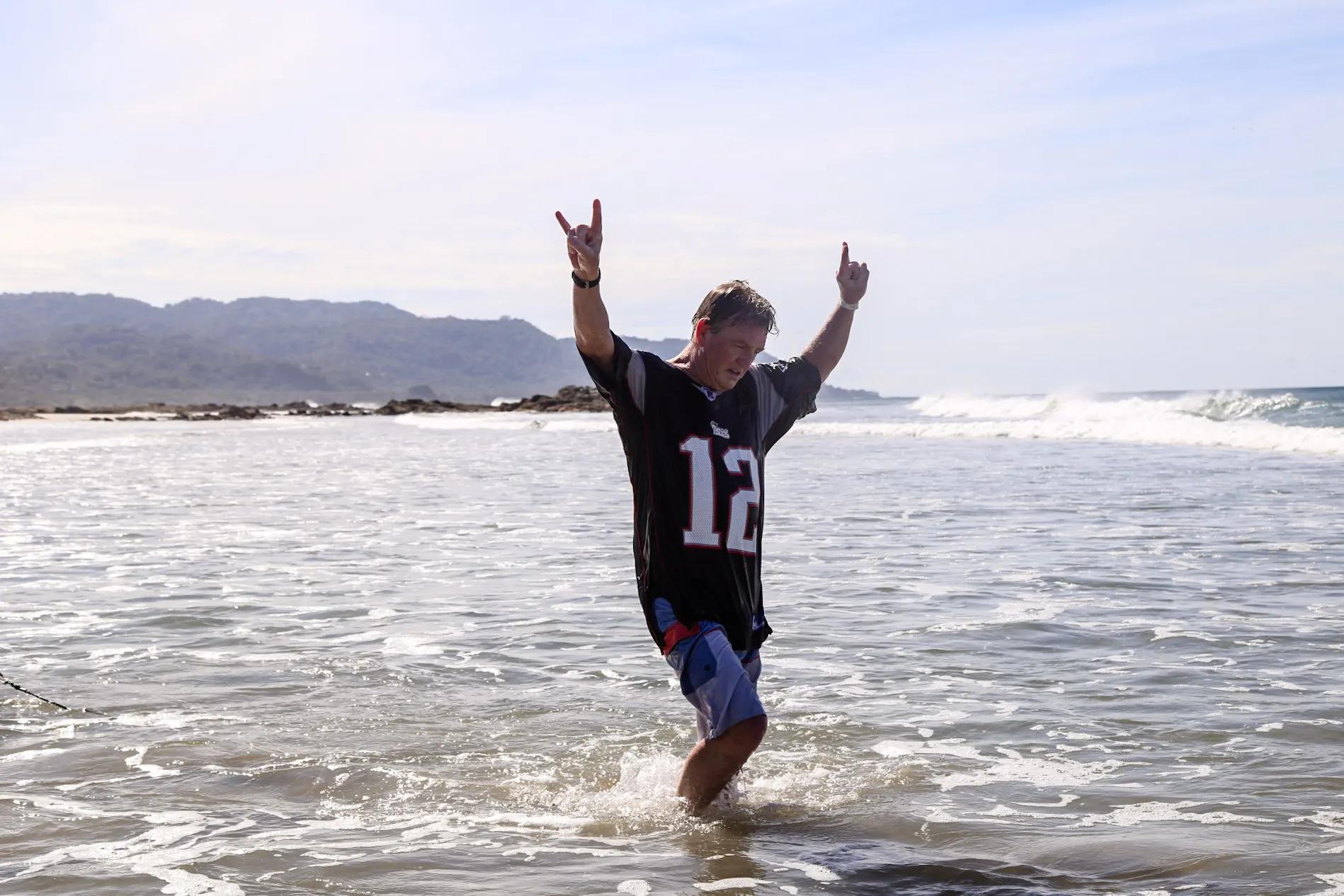 Real student surfing whitewater with instructor nearby in Santa Teresa
