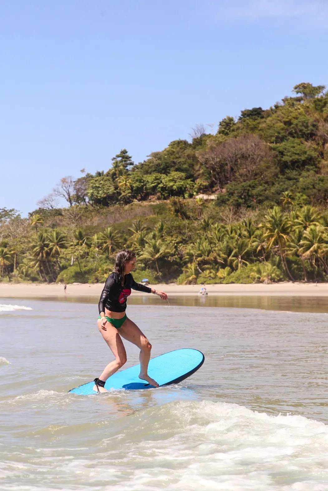 Beginner surfer improving stance and balance on a lesson wave in Santa Teresa