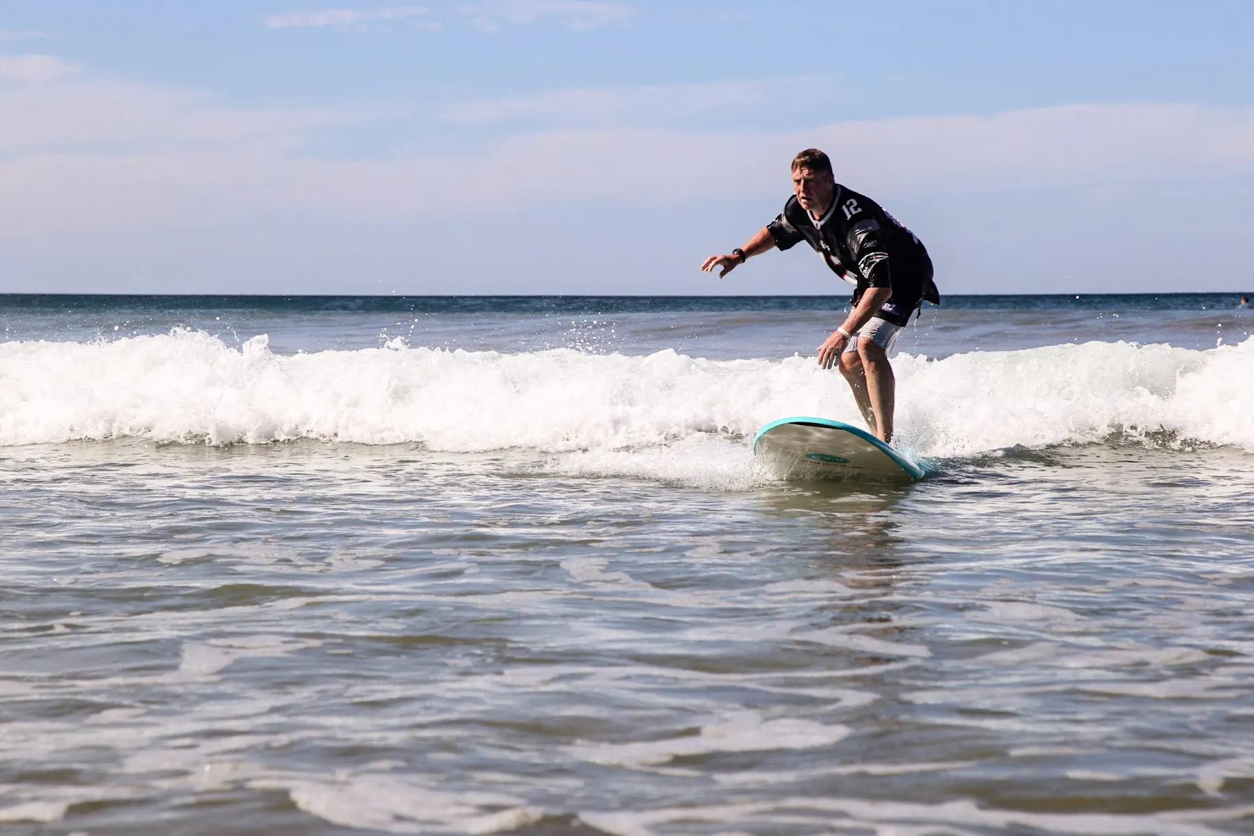 Student riding a wave with confidence in Santa Teresa Costa Rica surf class